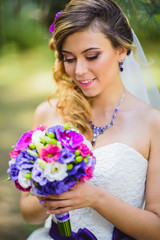 The girl in a wedding dress with purple bow