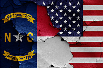 flags of North Carolina and USA painted on cracked wall