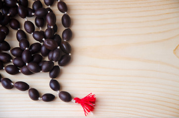 Mala beads for meditation on wood background. Close-up.