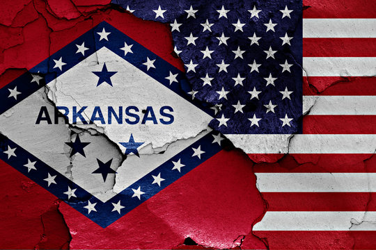 flags of Arkansas and USA painted on cracked wall