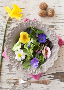 salad mix with edible flowers in spring background