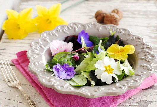 close up of spring salad with edible flowers