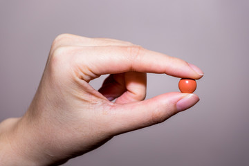 close up round pill in hand