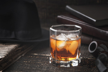 Whiskey with pipe , hat and newspaper horizontal