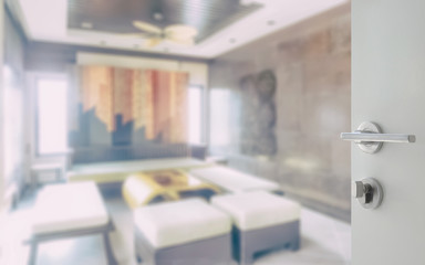 opened white door to classic style living room interior