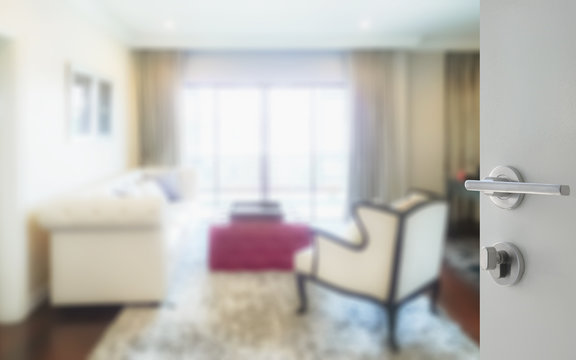 opened white door to luxury living room interior