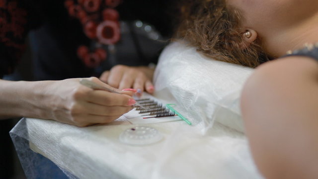 Female lashmaker work on tablet