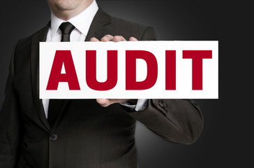 audit sign is held by businessman background