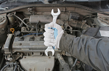 Wrench in the hand of auto mechanic