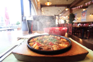 Fotobehang Served hot in a pan in a restaurant © kichigin19