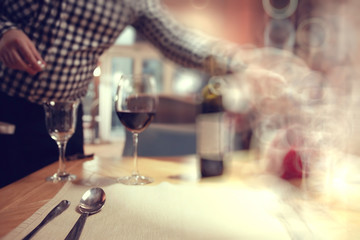 glass of wine, a restaurant serving a blurred background