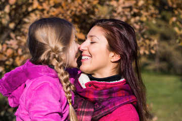 Mother and daughter in the park.happy mother and daughter in the autumn park