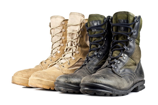two pairs of army boots isolated on white background