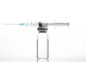 Glass Medicine Vial and Syringe on white background