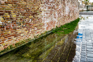 old brick wall in a puddle