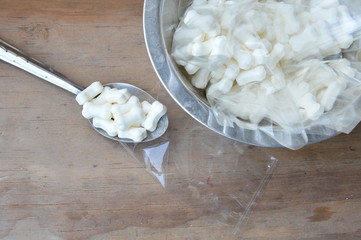 goat milk pallet for feeding pet packing in plastic bag by spoon