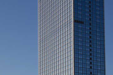 Fototapeta premium skyscraper - highrise building exterior on blue sky