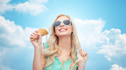 happy young woman in sunglasses eating ice cream