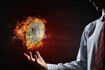 Euro coin burning in fire