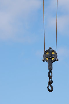 Vintage Black Crane Hook Isolated On Blue Sky