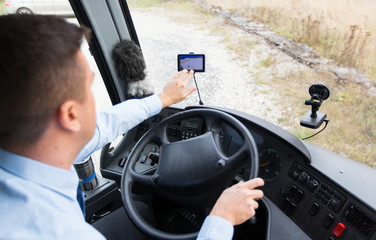 close up of bus driver driving with gps navigator