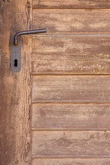 rust handle in old wooden door