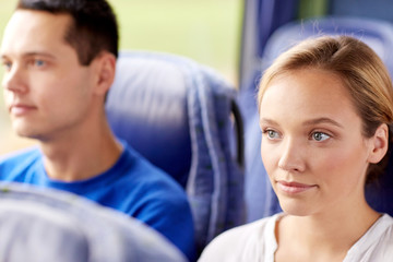 happy young woman sitting in travel bus or train