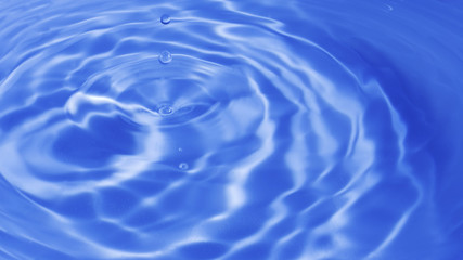 Water in motion as a beautiful bright blue water background (blurred drops of water falling down,...