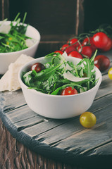 Healthy salad with rocket, tomato and parmesan cheese