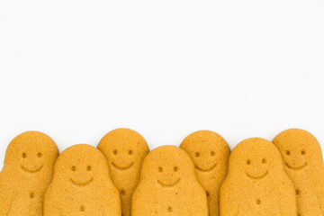 A row of happy gingerbread men on an isolated white background.