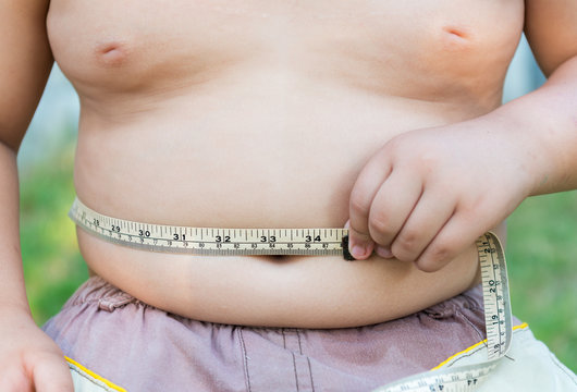 Fat boy measuring his belly.
