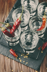Glasses of vodka with hot chili peppers
