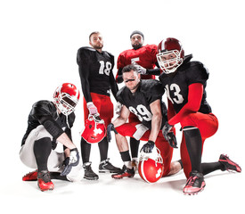 Naklejka na ściany i meble The five american football players posing with ball on white background