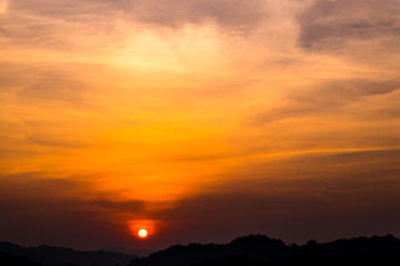 Sun setting over hills