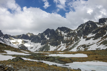 Fototapeta na wymiar Frozen lake in the High Tatra Mountains near Rysy peak and Strbske Pleso, Slovakia