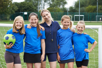 Portrait Of Girl's Soccer Team With Coach