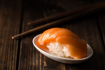 Salmon sushi nigiri on a dark wooden table