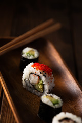 Healthy maki sushi on a wooden plate