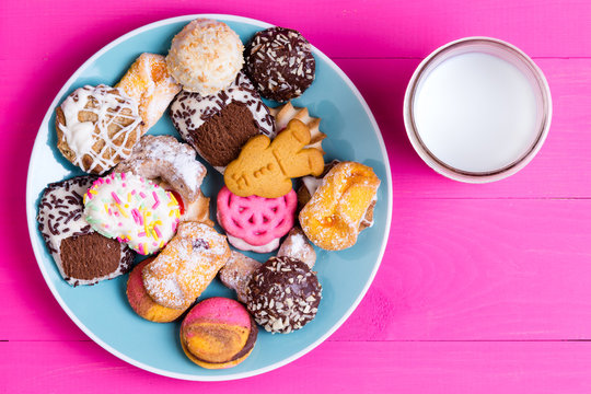 Plate Of Colorful Cookies With A Serving Of Milk