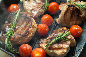 Grilled bbq steaks with fresh herbs and tomatoes