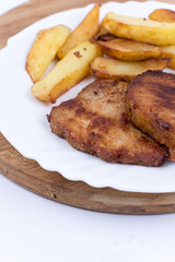 French fries with pork chops on the plate