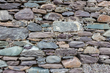 Ancient grey dry stone wall.  Can be used as background 