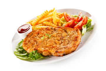 Fried pork chop, French fries and vegetables