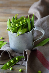 fresh green peas on rustic table