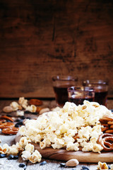 Sweet popcorn, salted cookies, sunflower seeds, pistachios on ol