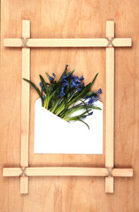 wooden frame with an envelope and flowers