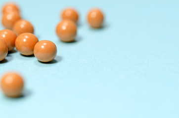 Orange colour of pills on blue background