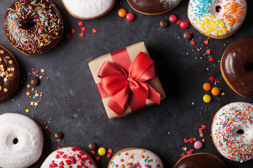Colorful donuts and gift box