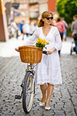 Urban biking - woman and bike in city 