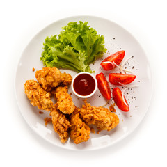 Fried chicken nuggets and vegetables